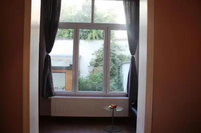 a window in a room with a table in front of it at EU B&B in Brussels