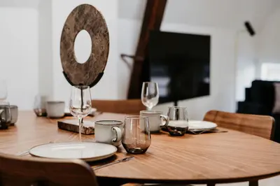 a wooden table with glasses and a mirror on it at Gorgeous duplex apartment in old city centre in Antwerp
