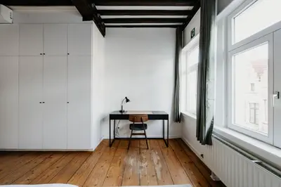 a room with a desk and a window at Gorgeous duplex apartment in old city centre in Antwerp