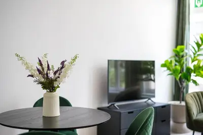 a table with a vase of flowers on it at Modern apartment in the old city center in Antwerp