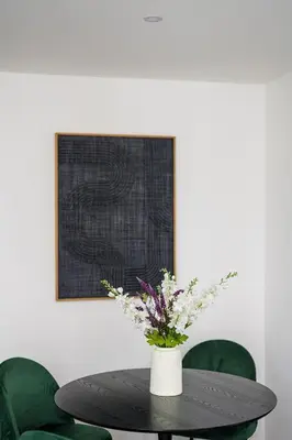 a table with a vase of flowers on it at Modern apartment in the old city center in Antwerp