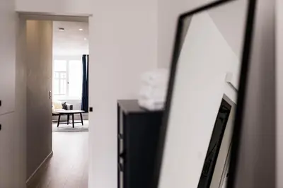 a hallway with a mirror and a living room at Gorgeous getaway in the old city centre of Antwerp in Antwerp
