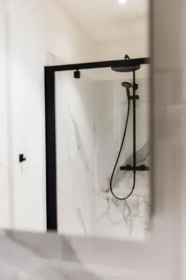 a bathroom with a mirror and a shower in it at Gorgeous getaway in the old city centre of Antwerp in Antwerp