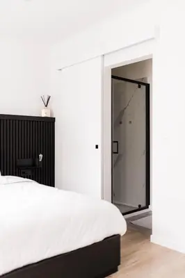 a bedroom with a bed and a glass door at Gorgeous getaway in the old city centre of Antwerp in Antwerp