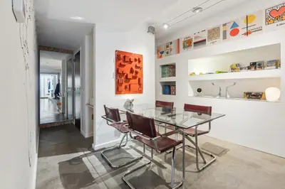 a dining room with a glass table and chairs at Cosy art studio near station with bikes and garden in Ghent