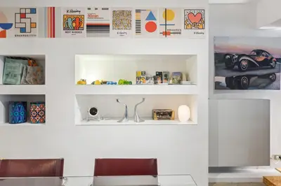 a room with white walls and white shelves at Cosy art studio near station with bikes and garden in Ghent