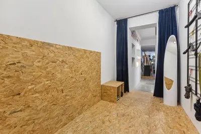 a room with a wall with a surfboard on it at Cosy art studio near station with bikes and garden in Ghent