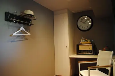 a room with a clock on the wall and a chair at Boat & Breakfast Bellevue in Ghent