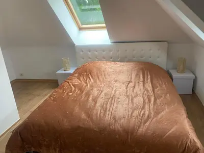 a bedroom with a large bed with two night stands at Bubbles and More Guesthouse in Begijnendijk