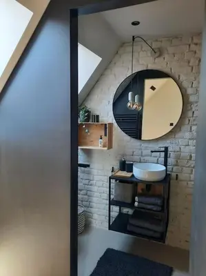 a bathroom with a sink and a mirror at Ateljee Sohie in Hoeilaart