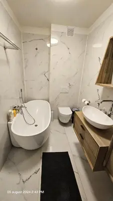 a bathroom with a tub and a sink and a toilet at Casa Luca in Grimbergen