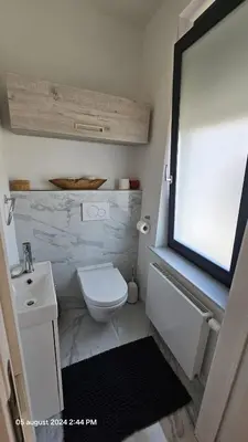 a bathroom with a white toilet and a sink at Casa Luca in Grimbergen