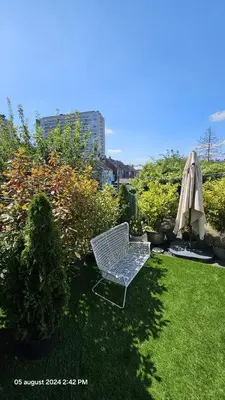 a chair and an umbrella in a yard at Casa Luca in Grimbergen