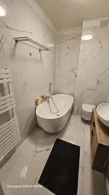 a white bathroom with a tub and a sink at Casa Luca in Grimbergen