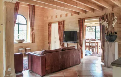 a living room with a couch and a tv at 2 Bedroom Cozy Home In Arendonk in Arendonk