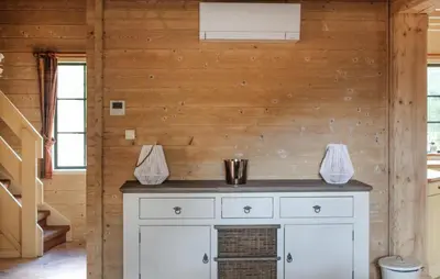 a white cabinet in a room with a wooden wall at 2 Bedroom Cozy Home In Arendonk in Arendonk