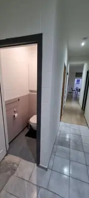 a bathroom with a toilet and a hallway at Worker's Lodge - 2 Bedrooms & Court yard - Antwerp Smooth Stays in Antwerp