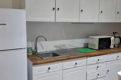 a kitchen counter with a sink and a microwave at Worker's Lodge - 2 Bedrooms & Court yard - Antwerp Smooth Stays in Antwerp