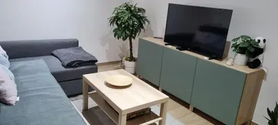 a living room with a couch and a flat screen tv at Worker's Lodge - 2 Bedrooms & Court yard - Antwerp Smooth Stays in Antwerp