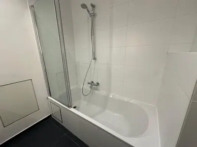 a bathroom with a shower and a bath tub at Spacious Apartment next to Port of Antwerp in Antwerp