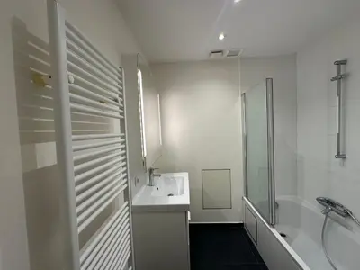 a white bathroom with a sink and a shower at Spacious Apartment next to Port of Antwerp in Antwerp