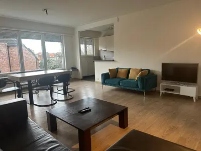 a living room with a couch and a table at Spacious Apartment next to Port of Antwerp in Antwerp
