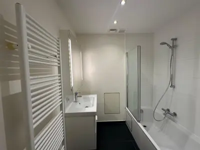 a white bathroom with a shower and a sink at Spacious Apartment next to Port of Antwerp in Antwerp