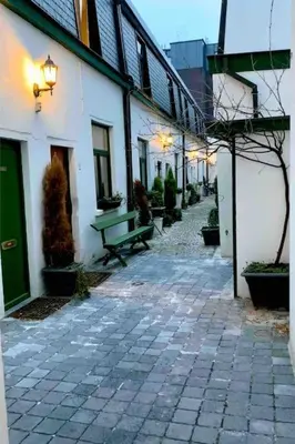 an alley with a green bench next to a building at Idyllische, historische woning op het hippe zuid in Antwerp