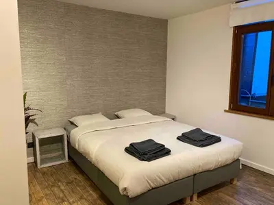 a bedroom with a bed with two black towels on it at Idyllische, historische woning op het hippe zuid in Antwerp
