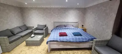 a bedroom with a bed and two couches at Studio Alex in Ghent