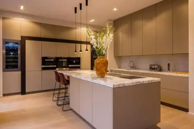 a kitchen with a vase of flowers on a counter at 1000m2 villa with indoor pool in Brussels