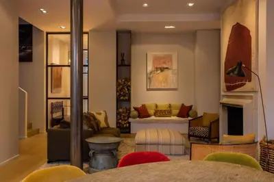 a living room with a couch and a fireplace at 1000m2 villa with indoor pool in Brussels