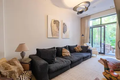 a living room with a couch and a window at 1000m2 villa with indoor pool in Brussels