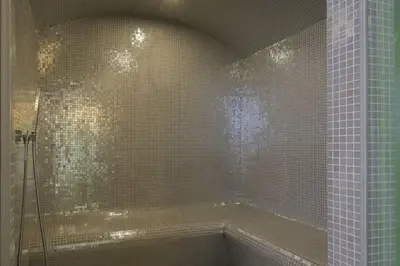 a bathroom with a tub and a shower with tiles at 1000m2 villa with indoor pool in Brussels