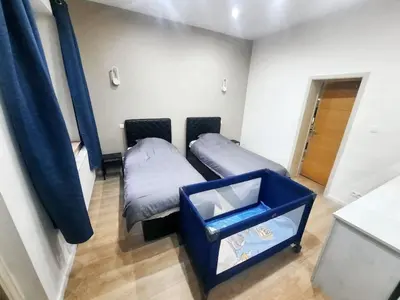 a room with two beds and a blue bin at Modern Apartment in Molenbeek-Saint-Jean / 77 m² / Parking in Brussels