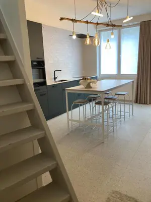 a kitchen with a table and chairs in a kitchen at Charmante stadswoning aan Groen Kwartier in Antwerp