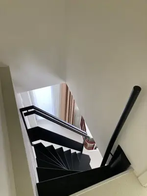 a spiral staircase in a building with a stair case at Charmante stadswoning aan Groen Kwartier in Antwerp