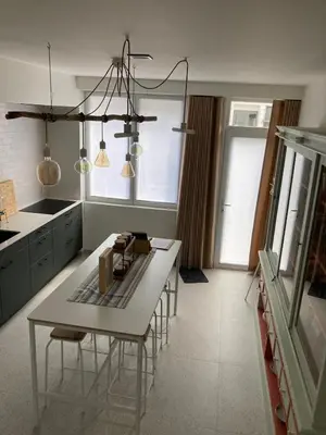 a kitchen with a table and chairs in it at Charmante stadswoning aan Groen Kwartier in Antwerp