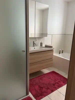 a bathroom with a sink and a bath tub at Tommorowland in Niel