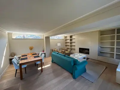 a living room with a blue couch and a table at Duplex Rosières - 12’ de Bruxelles in Rixensart