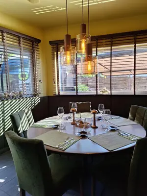 a dining room with a table with wine glasses at Den Ommegang in Halle