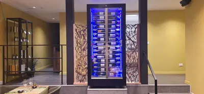 a blue glass wall in a lobby with a table at Den Ommegang in Halle