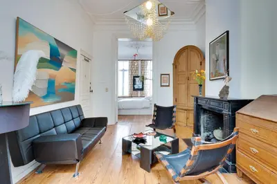a living room with a couch and a fireplace at Saint Catherine Art Residence in Brussels