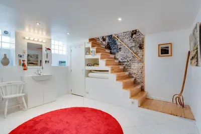 a room with a staircase with a red rug at Saint Catherine Art Residence in Brussels