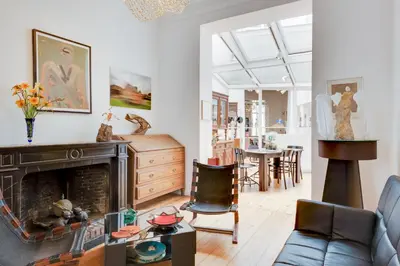 a living room with a couch and a fireplace at Saint Catherine Art Residence in Brussels