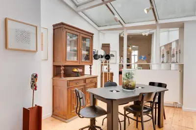 a dining room with a table and chairs at Saint Catherine Art Residence in Brussels