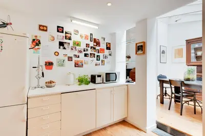 a kitchen with white cabinets and a table at Saint Catherine Art Residence in Brussels