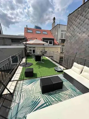a balcony with a view of a yard on a building at Duplex avec terrasse quartier européen in Brussels
