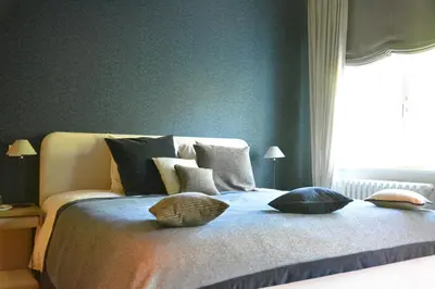a bedroom with a bed with three pillows on it at B & B Landhuis Ter Velt in Melle