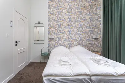 a white bed in a room with a wall at Room6 Van Lerius in Antwerp